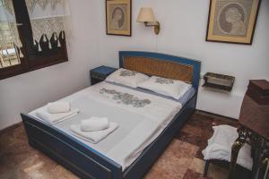 a bedroom with a bed with towels on it at Sea View Traditional Villa in Vourvourou