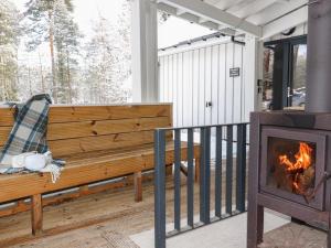 a wooden bench on a porch with a fireplace at Osprey Apartment in Kingussie +39 photos