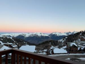 a view from the balcony of a ski resort with snow covered mountains at Studio La Plagne Villages in La Plagne Tarentaise +2 photos