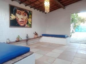 a room with two beds and a painting on the wall at Pousada Infinito Azul in Prea