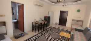 a living room with a table and a dining room at Private Rooms For Rent Near Airport - Raha Hostel in Ḩayl Āl ‘Umayr +16 photos
