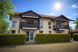 a building with bushes in front of it at *Premium-Apartment im Spreewald* in Burg