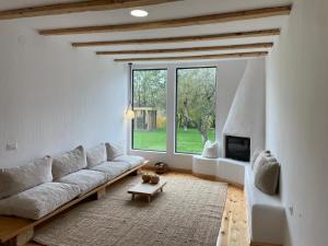 a living room with a couch and a large window at Doftana 609 in Trăisteni