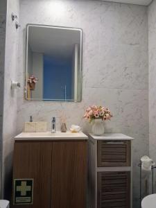 a bathroom with a sink and a mirror at White Design Apartment in Aveiro +34 photos