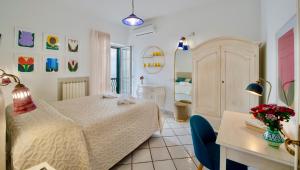 a bedroom with a bed and a desk and a room at Villa Il Lupo Felice - Panoramic Sea View Villa, Ravello in Ravello +61 photos