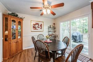 a dining room with a table and chairs and a ceiling fan at Kelly's Comfortable Quinton Home in Quinton