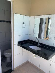 a bathroom with a sink and a toilet at Casa Camocim Marilago in Camocim +5 photos