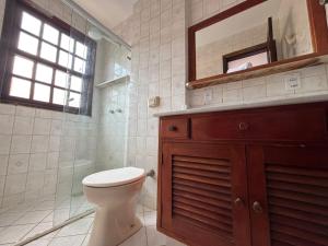 a bathroom with a toilet and a sink and a mirror at POUSADA BELLA SPIAGGIA in Paraty +37 photos