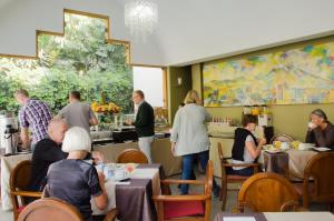 a group of people sitting at tables in a restaurant at La Maison d'Elise in Arequipa