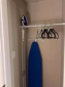 a blue surfboard is hanging on a shelf at Skipper Apt 1 in Rockingham