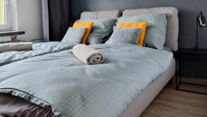 two beds with a towel on them in a bedroom at Green apartament 21 in Oświęcim