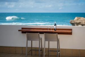 a bar with two wine glasses and a bottle of wine at Terregal in Ajuy