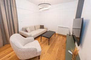 a living room with a couch and a chair at The Watermill Lodge in Kolašin