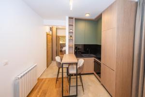 a kitchen with a table and chairs in a room at The Watermill Lodge in Kolašin