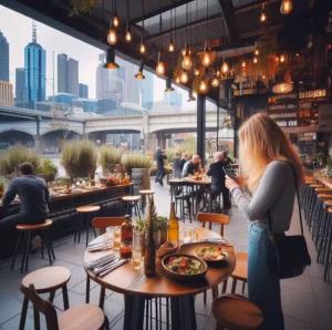 a woman sitting at a table in a restaurant at Splendid Spacious - Port Melbourne Beachside Home in Melbourne