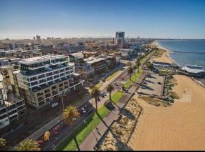 an aerial view of a city with a beach and buildings at Splendid Spacious - Port Melbourne Beachside Home in Melbourne