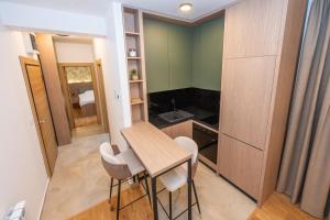 a small kitchen with a small table and chairs at The Watermill Lodge in Kolašin +10 photos