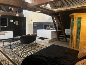 a room with a fireplace and a chair and a ladder at Eden spa appartement d’exception in Dijon