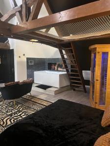 a bedroom with a loft bed and a fireplace at Eden spa appartement d’exception in Dijon