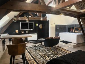 a living room with a fireplace and a table and chairs at Eden spa appartement d’exception in Dijon