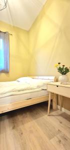 a bedroom with a bed and a table with a plant at Leilighet i Sokndal in Sokndal