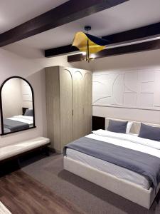 a bedroom with a large bed and a mirror at Château Byurakan Hotel in Byurakan +63 photos