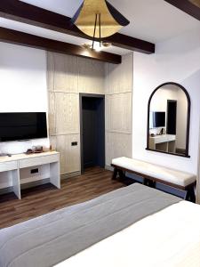 a bedroom with a bed and a large mirror at Château Byurakan Hotel in Byurakan
