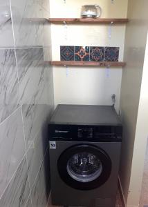 a washer and dryer in a small room at Cheerful 3 bedroom home with stunning views in Quartier la Fleury Guiné +22 photos