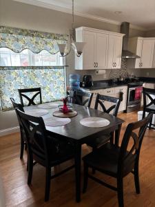 a kitchen with a table and chairs in a kitchen at 12Birchwood in Holbrook