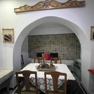a dining room with a table and two chairs at Dar EMNA in Kairouan +9 photos