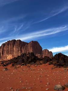 a group of rocks in the desert under a blue sky at Wadi rum fun time in Wadi Rum