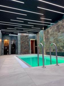 a swimming pool in a building with a ceiling at Château Byurakan Hotel in Byurakan