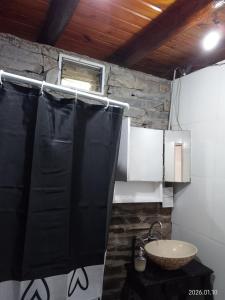 a bathroom with a black shower curtain and a sink at Espacio de relax in Trapiche +30 photos