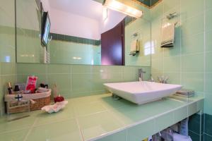 a bathroom with a sink and a mirror at The Captain's View in Aegina +26 photos