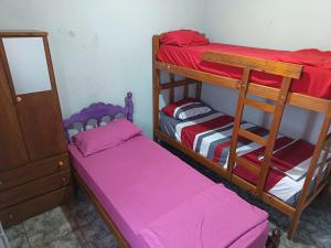 two bunk beds in a room with pink sheets at jazmin apart iguazu in Puerto Iguazú +19 photos