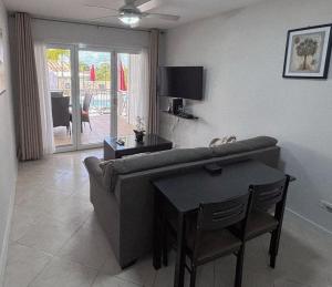 a living room with a couch and a table at Lantana 8 in Saint James
