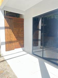 a room with a sliding door and a window at Pousada Leve Mar in Ilhéus