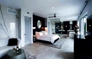 a bedroom with a bed and a living room at Tropical Paradise in Leeward