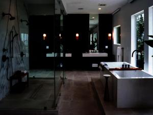 a bathroom with a shower and a sink and a tub at Tropical Paradise in Leeward