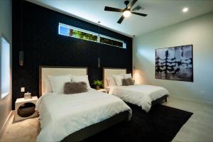 a bedroom with two beds and a ceiling fan at Tropical Paradise in Leeward