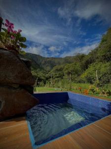 a swimming pool with a view of a mountain at Cabaña en Chachimbiro in Hacienda San Francisco