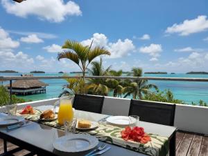 a table with food and a view of the ocean at Large studio facing lagoon in Bora Bora
