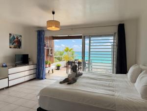 a bedroom with a large bed with a view of the ocean at Large studio facing lagoon in Bora Bora