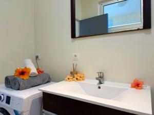 a bathroom with a sink and a mirror on the wall at Large studio facing lagoon in Bora Bora