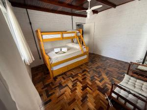 a bedroom with a bunk bed and a wooden floor at Gastehaus Watzko in Piçarras