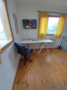 a desk in a room with a chair and a window at amailen ushuaia in Ushuaia