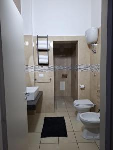 a bathroom with a toilet and a sink at Officina dei ricordi in Casagiove +46 photos