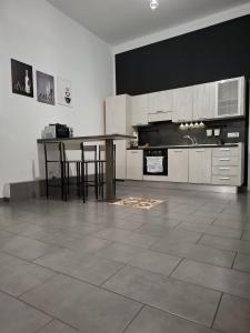 a kitchen with a table and some chairs in it at Officina dei ricordi in Casagiove
