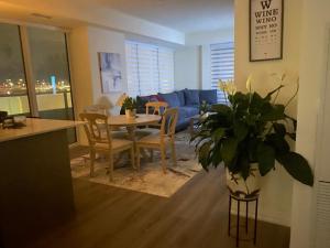 a living room with a table and a couch at Modern Private Room with Ensuite in Vaughan