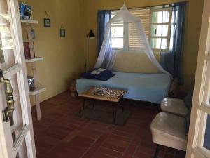 a bedroom with a bed and a window and a table at Beautiful Cottage overlooking Sea in Goodwood